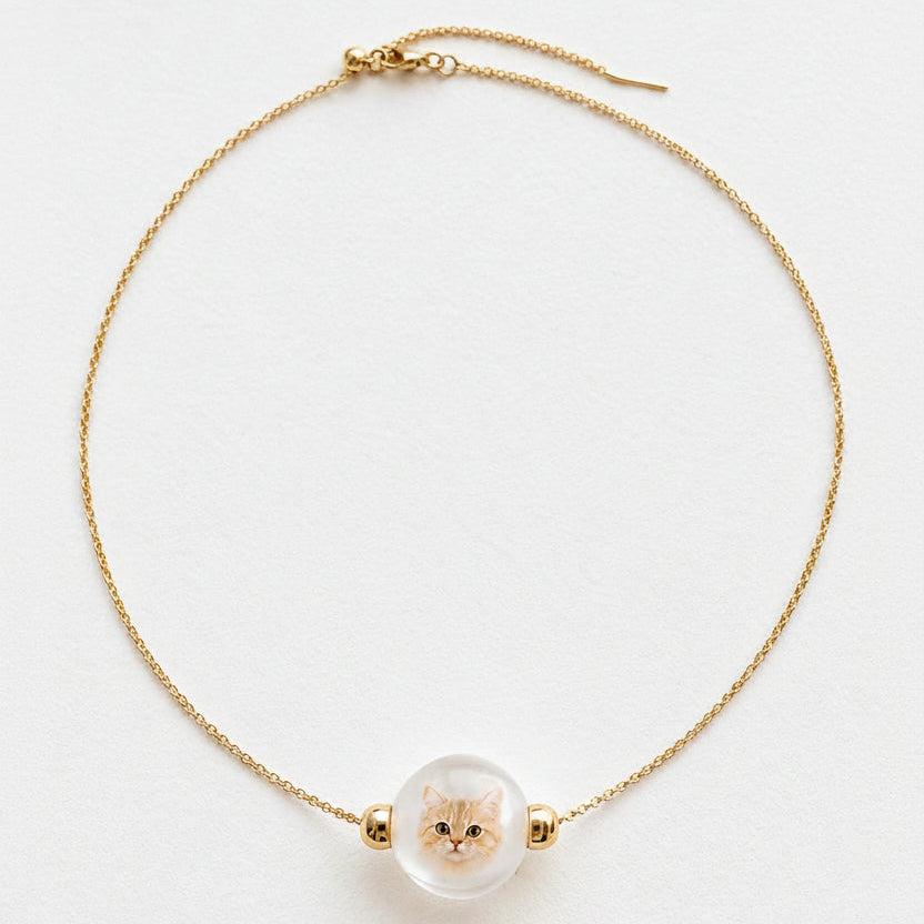 Custom pet portrait necklace showing a hand-painted dog portrait inside a glass bead