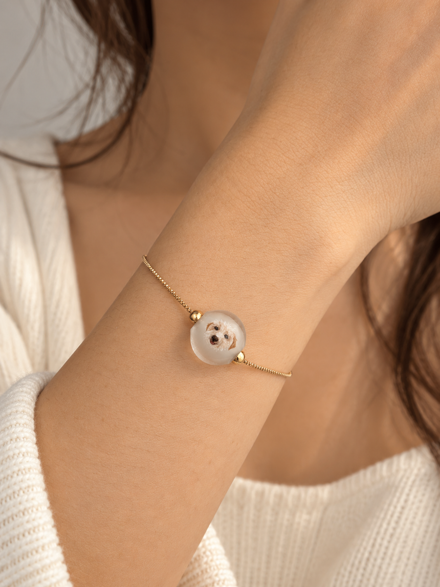 Custom dog portrait bracelet worn by a model