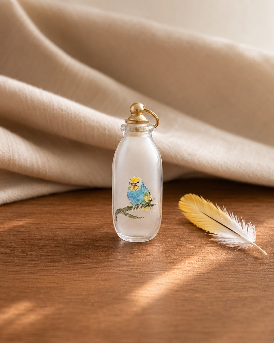 Finished hand-painted blue budgie portrait glass keepsake with a gold-tone closure