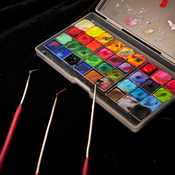 Real pigment palette and fine hooked brushes used by EVERWITHIN artists