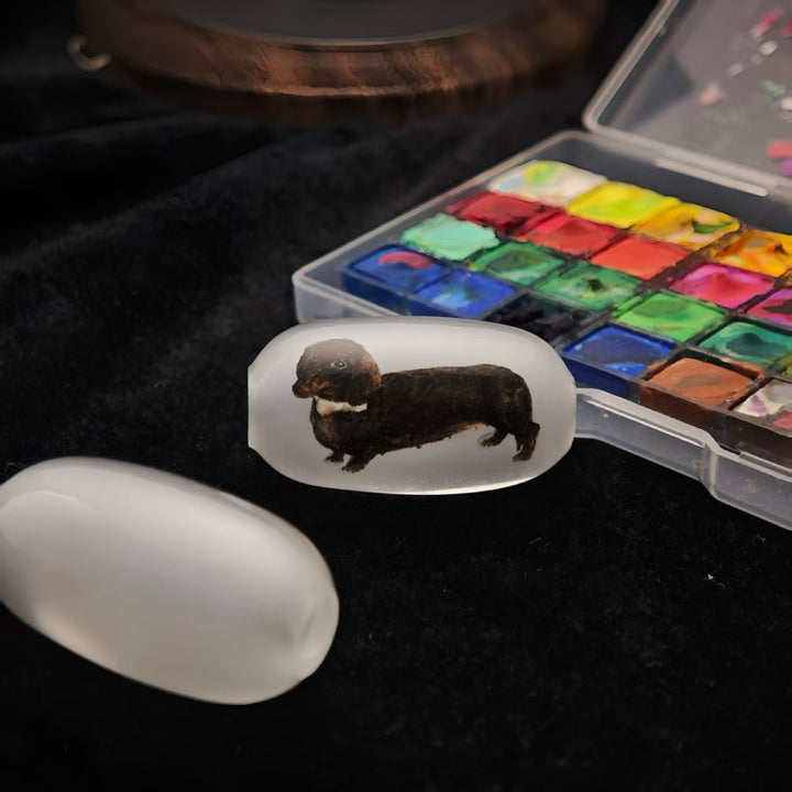 Watercolor and mineral pigments used to build a pet portrait inside glass