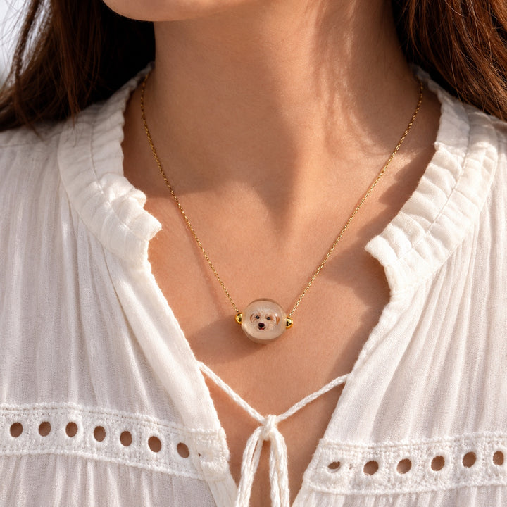 Custom pet portrait necklace worn by a model