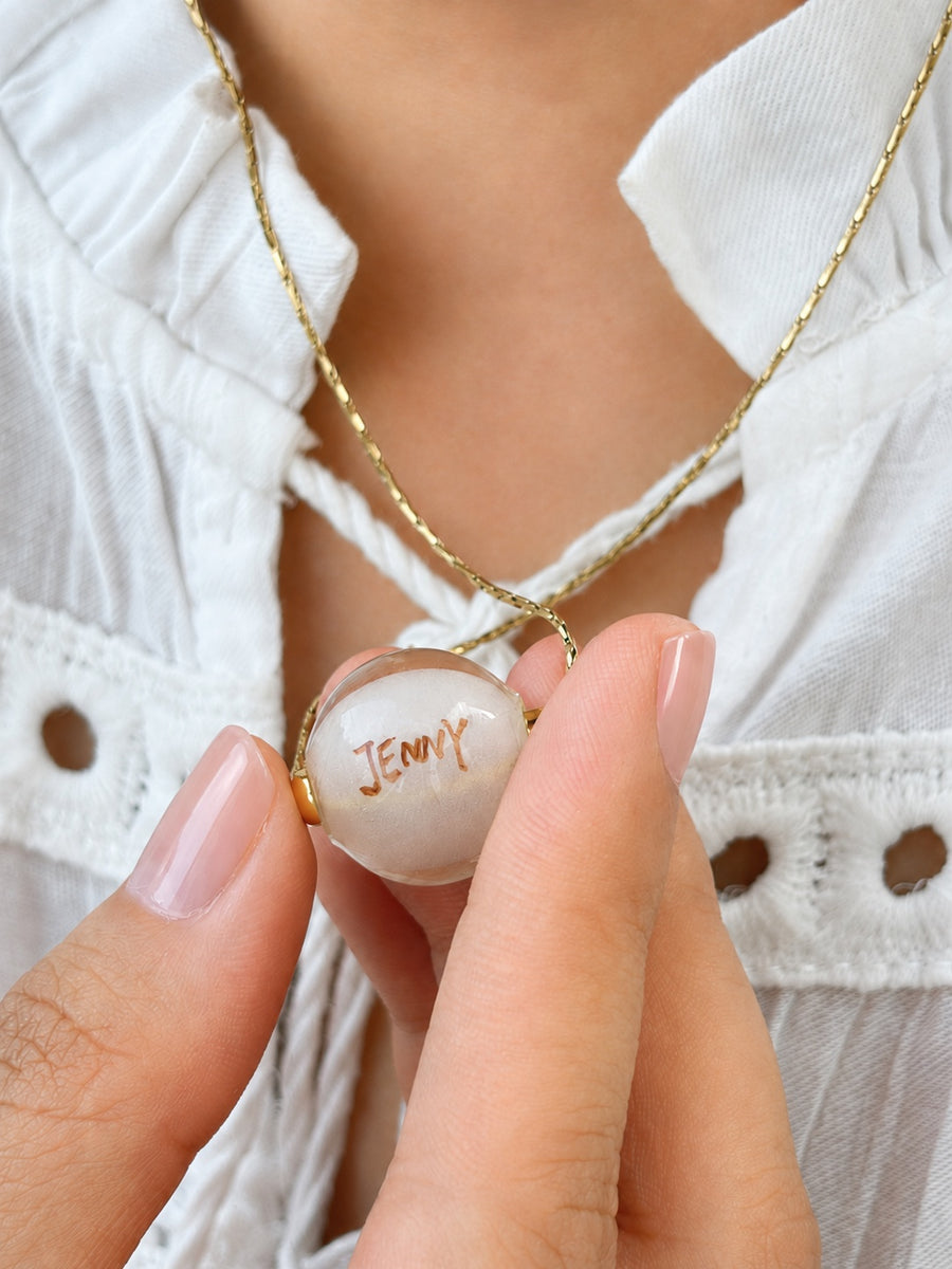 Personalized reverse of a 16mm custom pet portrait necklace bead painted with the name Jenny
