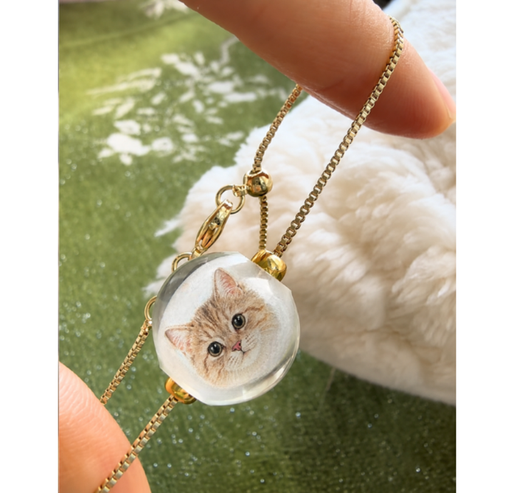 Close-up of a custom cat portrait bracelet in gold-tone titanium steel