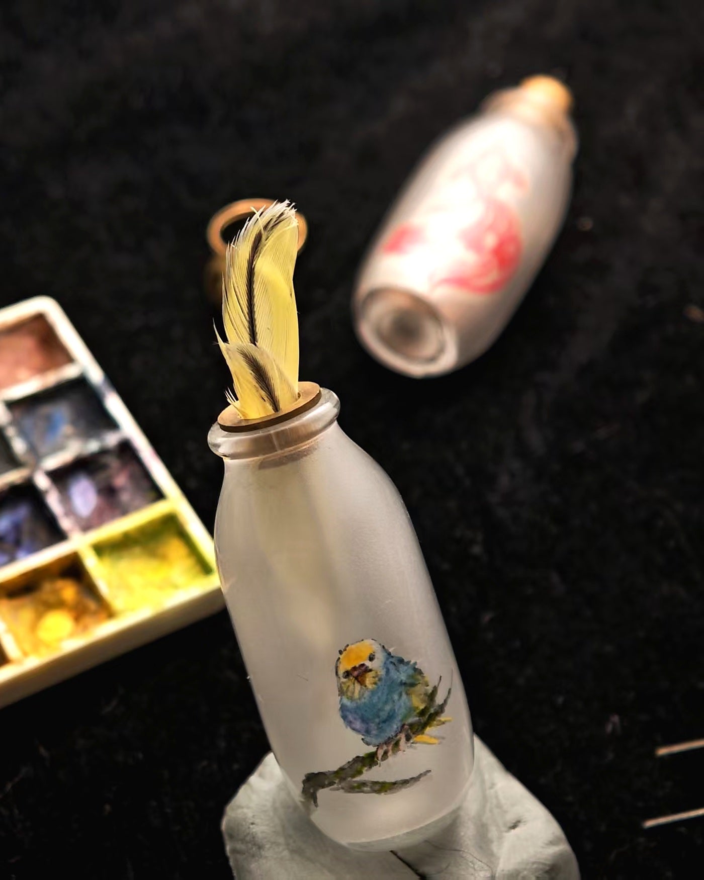 Custom bird feather and pet fur keepsake with hand-painted bird detail