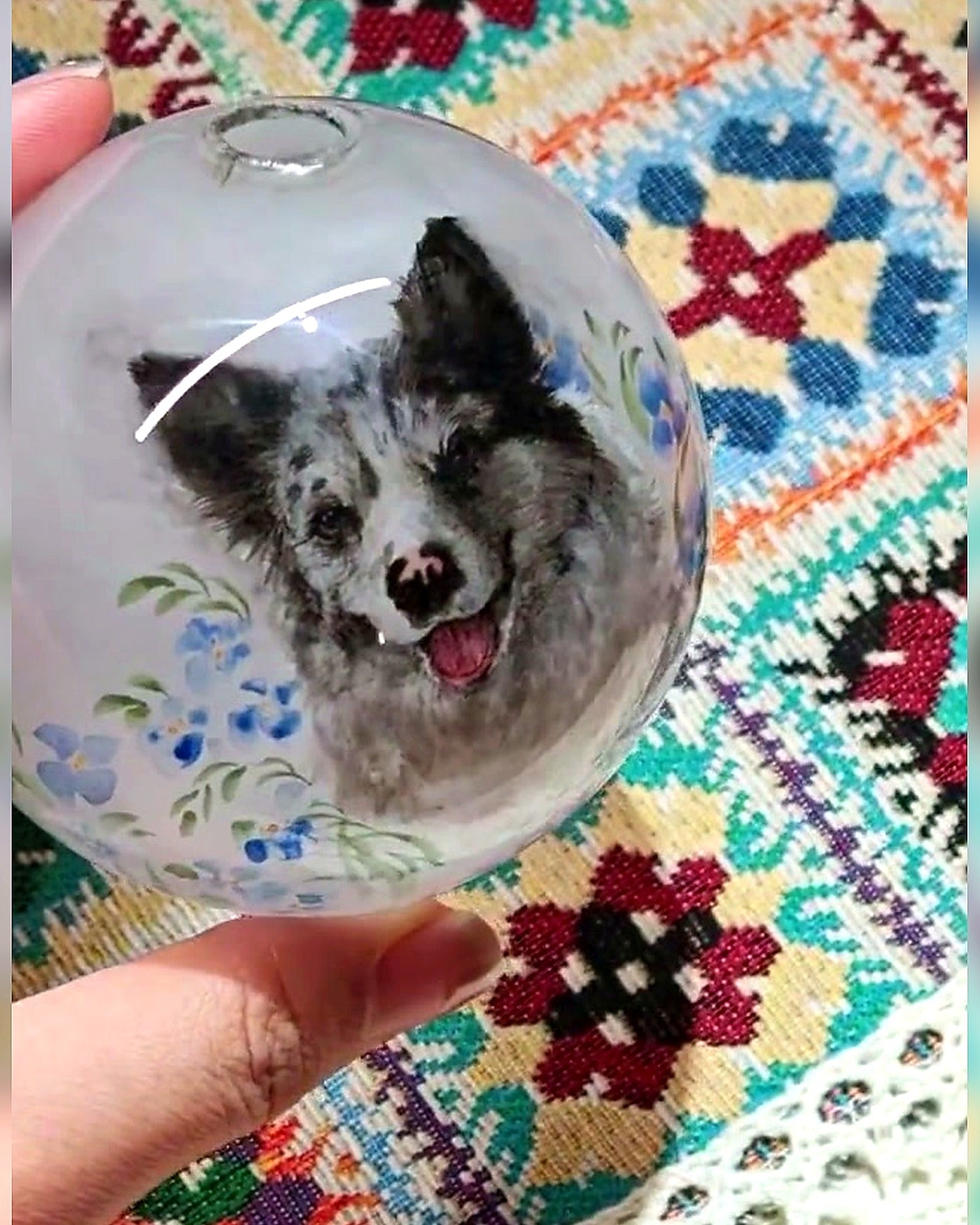 Finished border collie Christmas glass ornament with a festive textile background